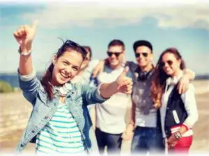 teenage girl with headphones and friends outside