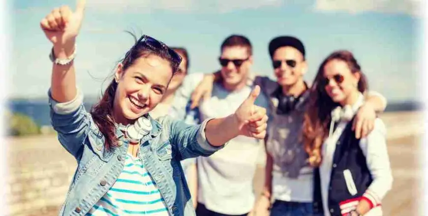 teenage girl with headphones and friends outside